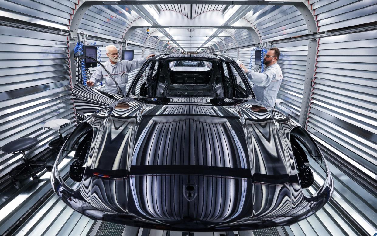 Workers assemble a Porsche Macan model in Germany