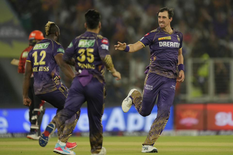 Kolkata Knight Riders' Mitchell Starc, right, celebrates with teammates after the dismissal of Sunrisers Hyderabad's Travis Head during the Indian Premier League qualifier cricket match between Kolkata Knight Riders and Sunrisers Hyderabad in Ahmedabad, India, Tuesday, May 21, 2024. (AP Photo/Ajit Solanki)