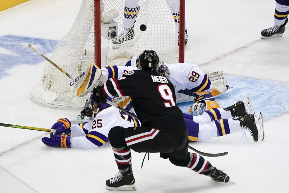 St. Cloud State's Spencer Meier (9) scores on Minnesota State goaltender Dryden McKay (29) during the first period of an NCAA men's Frozen Four hockey semifinal in Pittsburgh, Thursday, April 8, 2021. (AP Photo/Keith Srakocic)