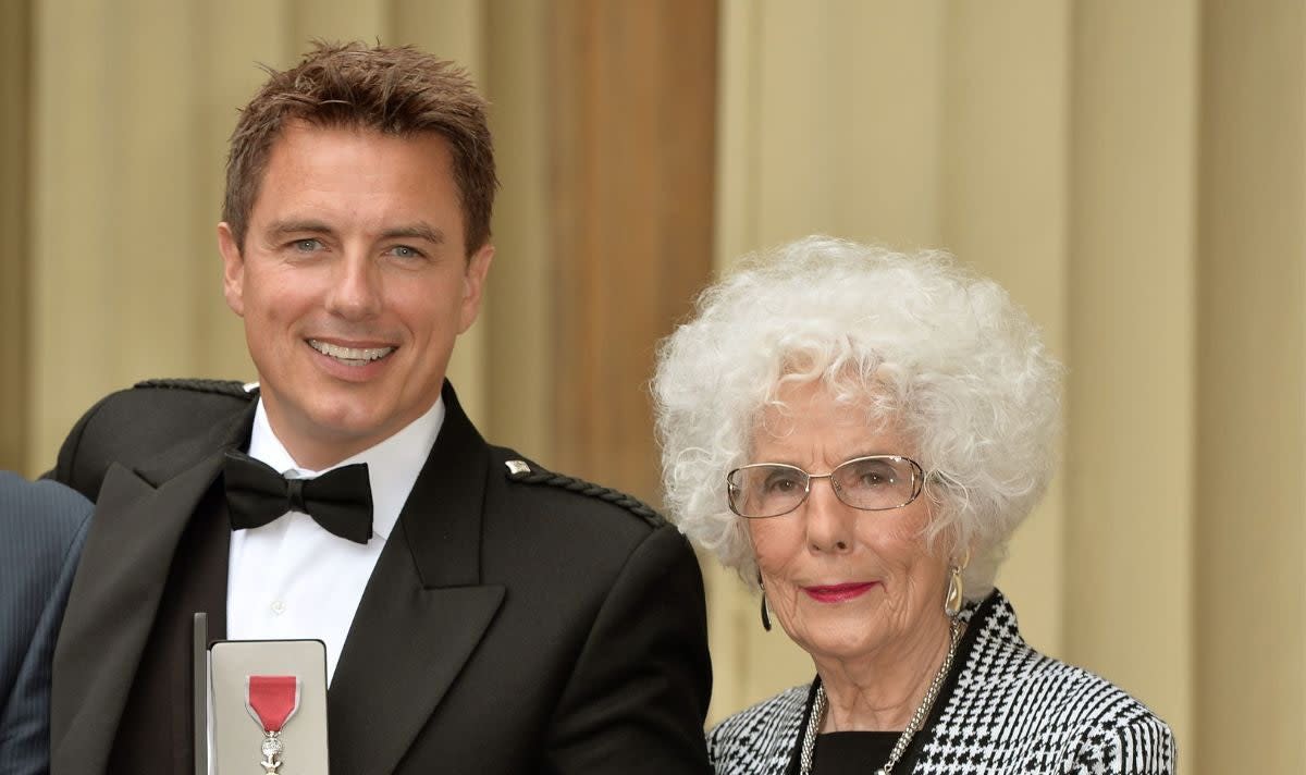 John Barrowman (L) has stopped work obligations to be by his hospitalised mother, Marion’s (R) bedside  (PA)