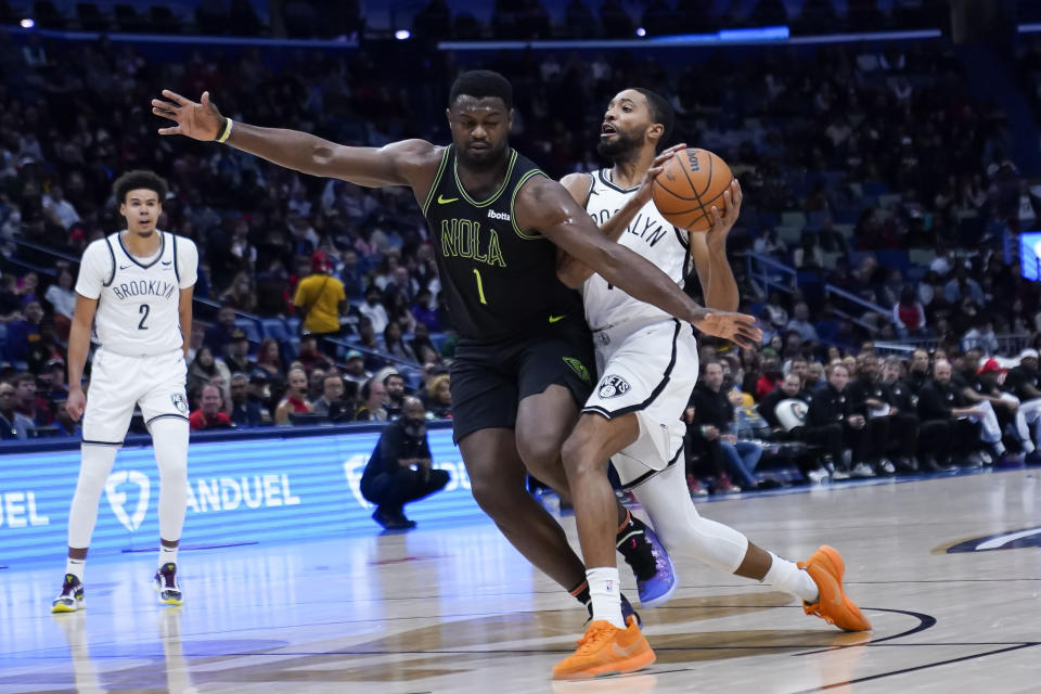 Brooklyn Nets forward Mikal Bridges is fouled as he drives to the basket against New Orleans Pelicans forward Zion Williamson (1) in the first half of an NBA basketball game in New Orleans, Tuesday, Jan. 2, 2024. (AP Photo/Gerald Herbert)