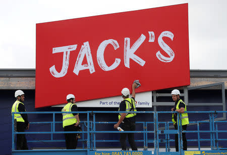 Workers unveil the branding at Tesco's new discount supermarket Jack's, in Chatteris, Britain, September 19, 2018. REUTERS/Chris Radburn