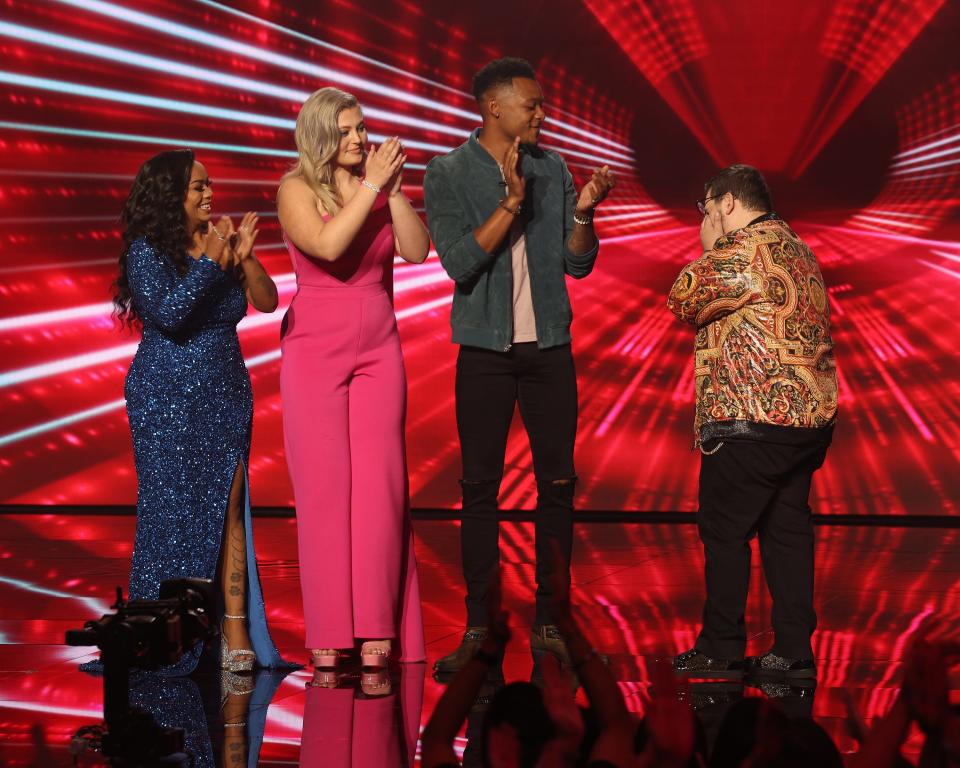 Walsh Jesuit's Emyrson Flora, second from left, reacts to the news Sunday night that she had been eliminated from "American Idol" and was not among the Top 7 to continue on.