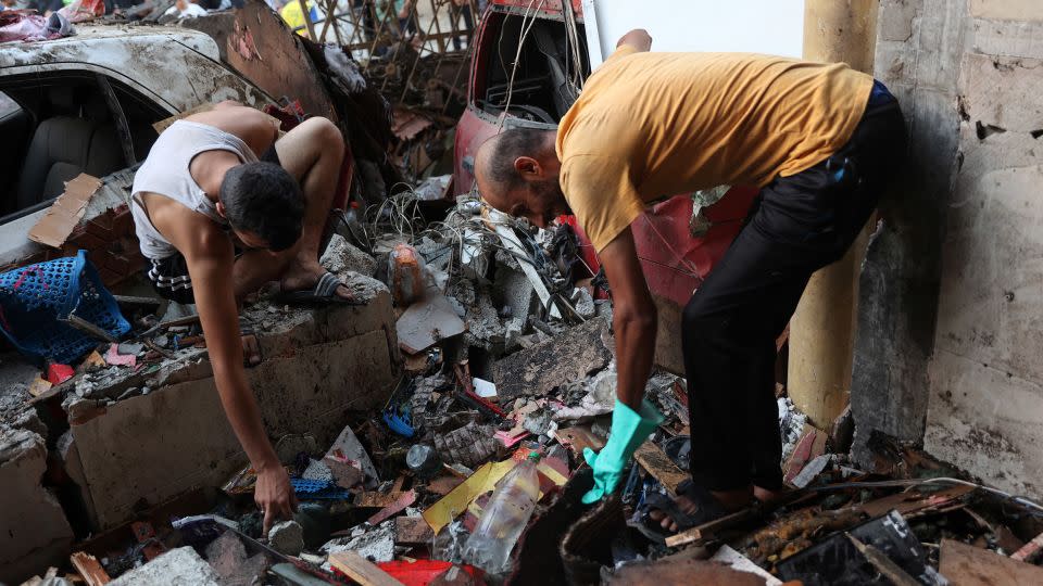 People sift through the rubble inside a Gaza school struck by the IDF on August 10, 2024. - Omar al-Qattaa/AFP/Getty Images