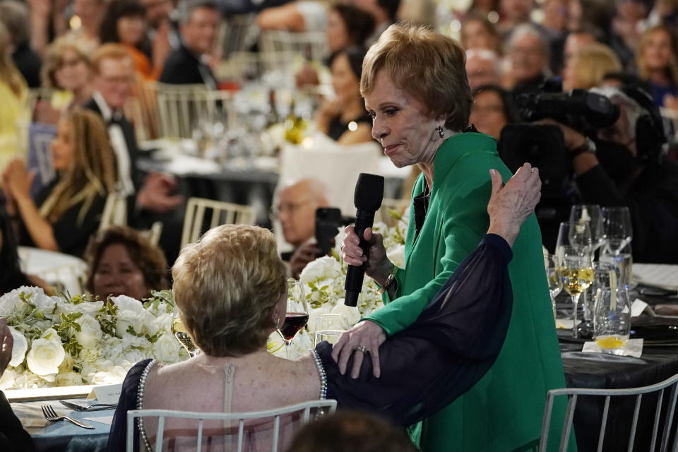 Comedian Carol Burnett, right, addresses actor Julie Andrews during the 48th AFI Life Achievement Award Gala honoring Andrews, Thursday, June 9, 2022, at the Dolby Theatre in Los Angeles. (AP Photo/Chris Pizzello)