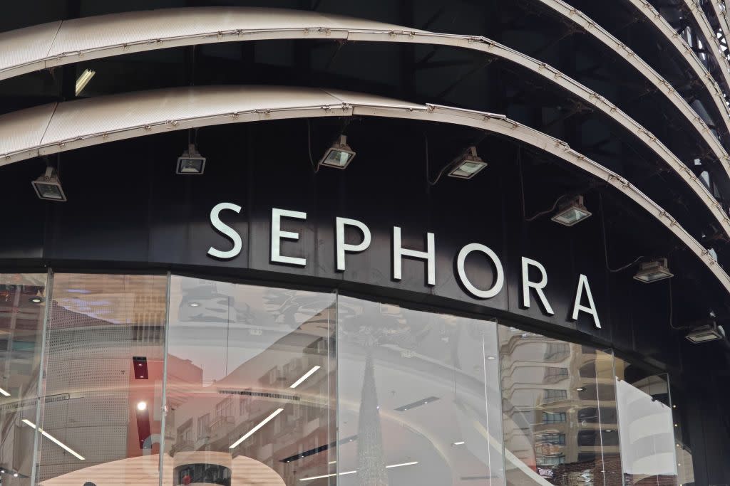 a sephora store sign with glass front below it
