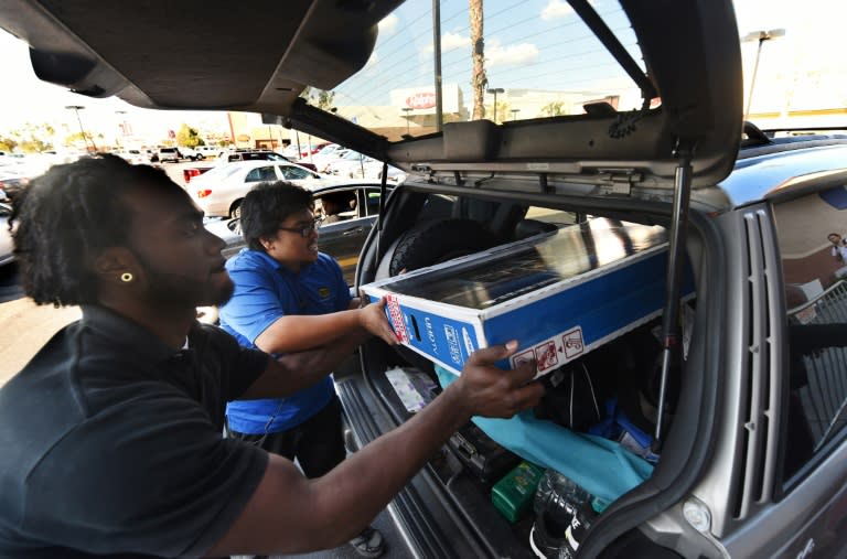 Best Buy staff load a television during a sale in Los Angeles, California on November 27, 2015