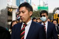 Hong Kong detective Kwan Ka-ho (front) -- who was one of seven police officers who allegedly beat activist Ken Tsang during the 2014 pro-democracy protests -- arrives at the Hong Kong District Court on February 14, 2017