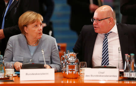 Acting German Chancellor Angela Merkel talks with Head of the Federal Chancellery Peter Altmaier as she meets city mayors at Chancellery in Berlin, Germany, November 28, 2017. REUTERS/Hannibal Hanschke