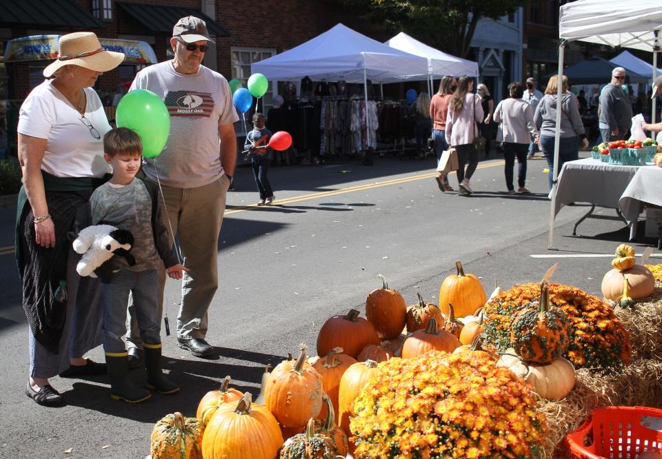 Visitors look over the pumpkin selection at the Gallatin Main Street Festival in 2020.