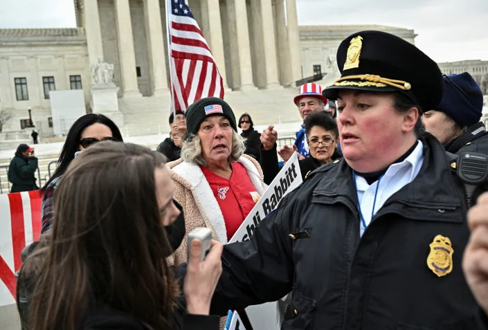Micki Witthoeft watches a police officer separate a counterprotester from her group.