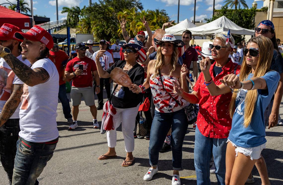 Trump supporters dance in the streets as they patiently wait in the hot sun to get into Ted Hendricks Stadium for the rally in Hialeah on Wednesday, November 8, 2023. On the night of the RNC debate in Miami, former President Donald Trump will hold a rally in Hialeah.