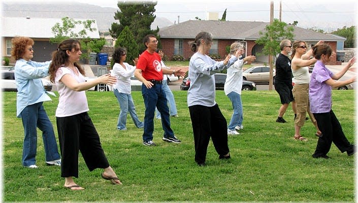 Students of Raymond Abeyta's Tai Chi class practice Tui Shou or "push hands" during a lesson.