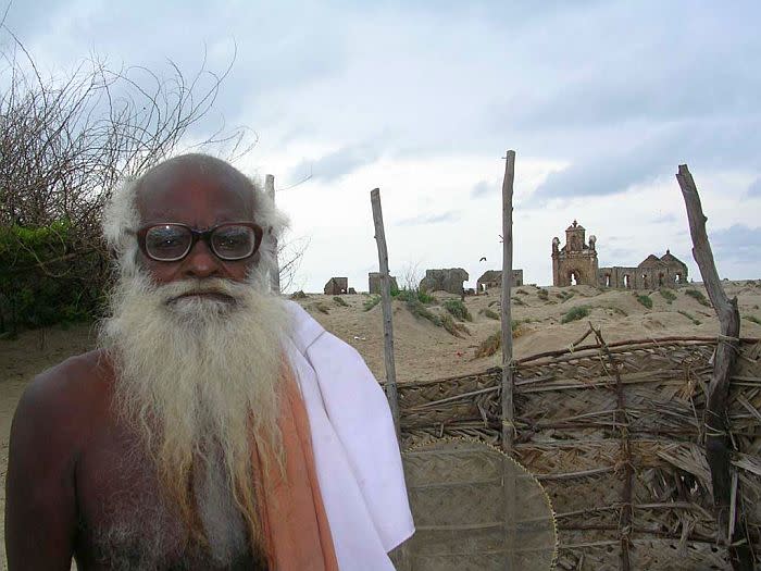 A survivor of the 1964 cyclone who now lives in Dhanushkodi supplies drinking water to tourists from a well on Dhanushkodi beach.