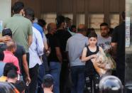 FILE PHOTO: People queue to buy bread at a bakery in Beirut