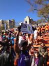 People in the still set-up finish line stands cheering thousands of unofficial #NYCMarathon runners.