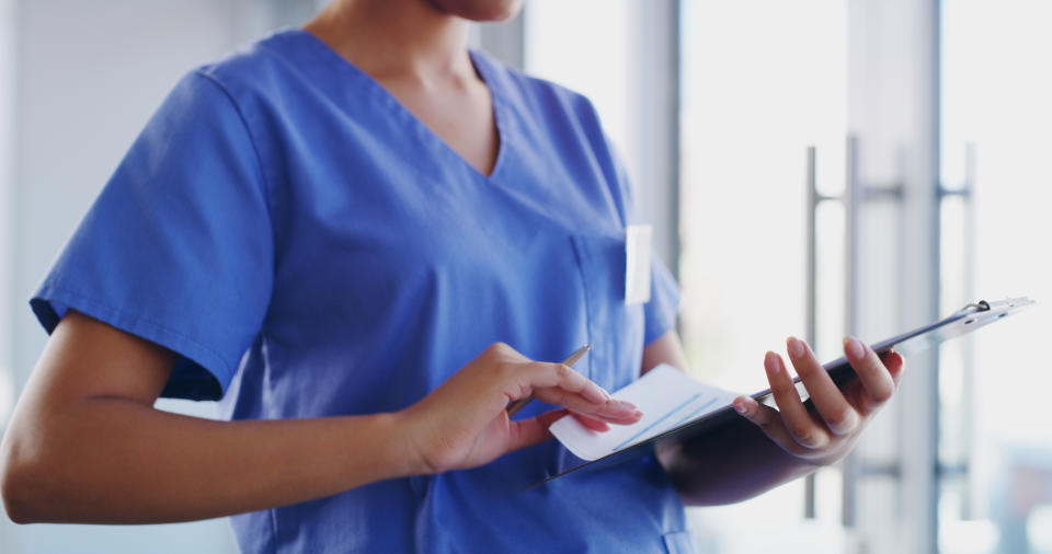 Cropped shot of a doctor holding a clipboard modern hospital