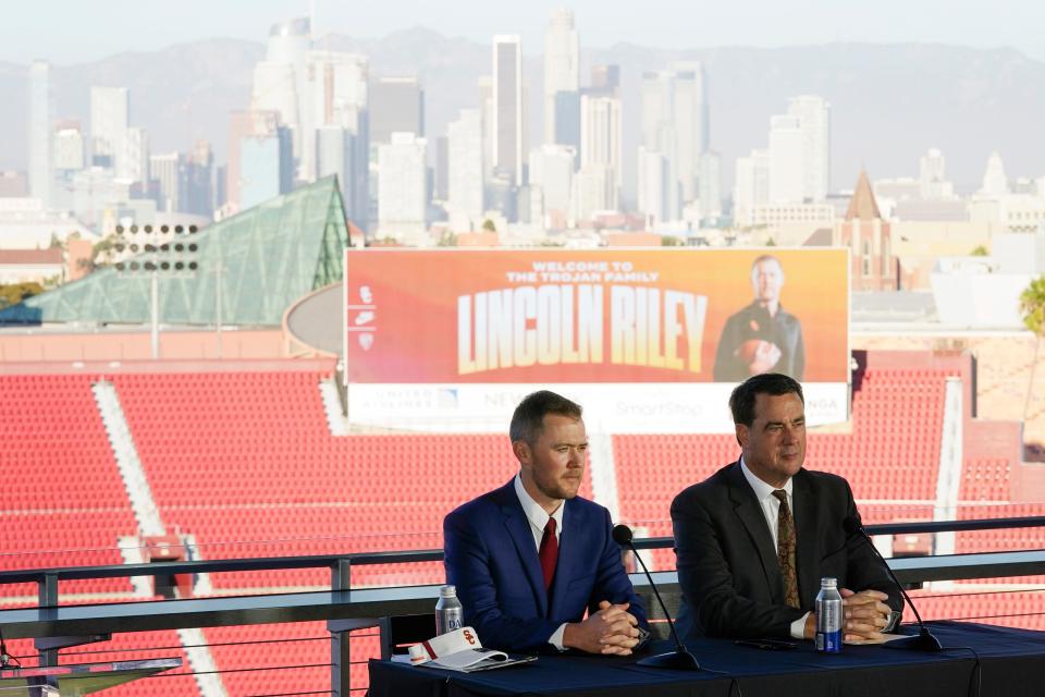 Lincoln Riley, left, the new head football coach of the University of Southern California, and Athletic Director Mike Bohn, right, answer questions during a ceremony in Los Angeles, Monday, Nov. 29, 2021. (AP Photo/Ashley Landis)