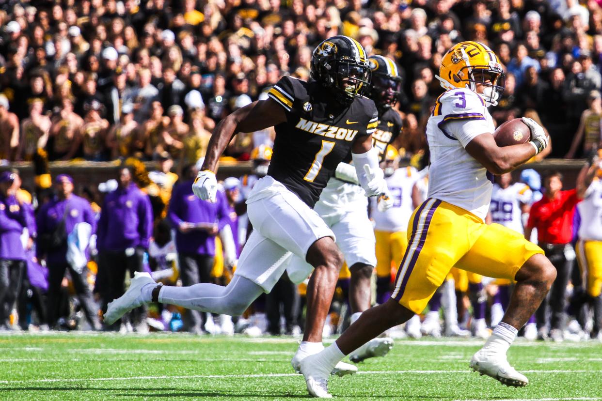 LSU running back Logan Diggs (3) speeds past Missouri safety Jaylon Carlies (1) during Missouri's game against LSU at Faurot Field on Oct. 7, 2023, in Columbia, Mo.