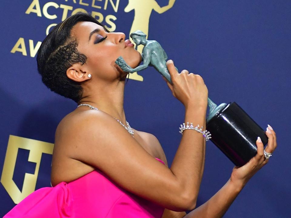 Ariana DeBose kisses her SAG award for best supporting actress at the 2022 SAG Awards