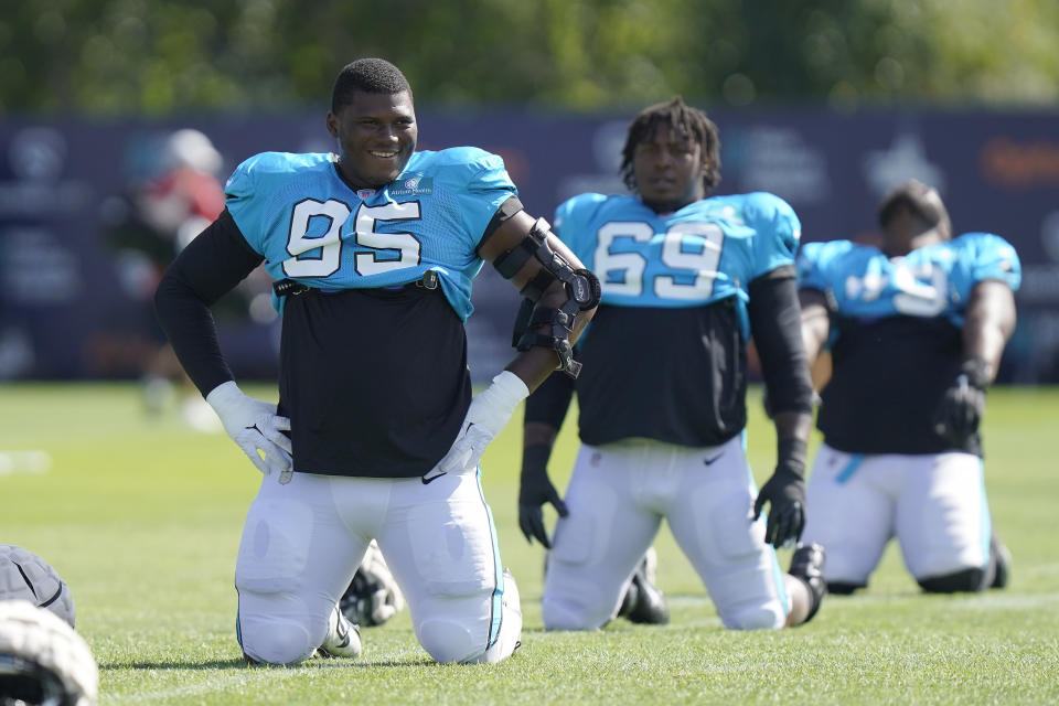 Carolina Panthers defensive tackle Derrick Brown (95) warms up in front of defensive end Frank Herron (69) during a NFL football joint practice with the New England Patriots, Tuesday, Aug. 16, 2022, in Foxborough, Mass. (AP Photo/Steven Senne)