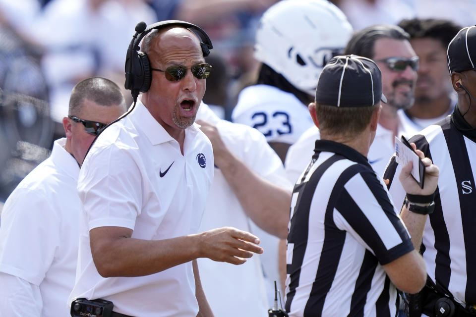 Penn State head coach James Franklin talks to an official during the first half of an NCAA college football game against Illinois, Saturday, Sept. 16, 2023, in Champaign, Ill. (AP Photo/Charles Rex Arbogast)