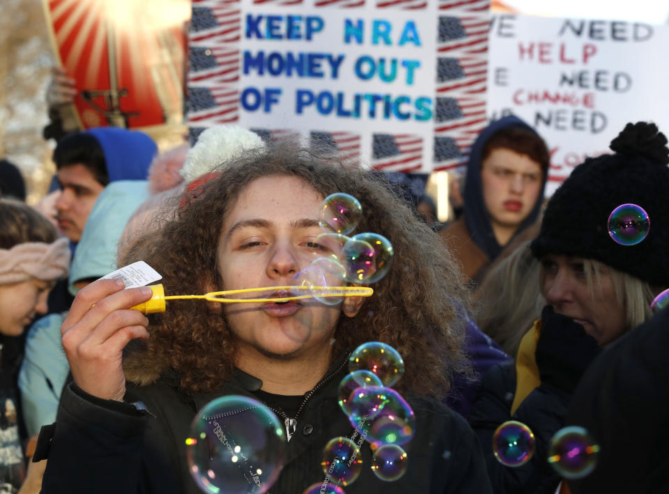 <p>J.J. Miller,17, from Baltimore blows bubbles as crowds arrive for the March for Our Lives rally in support of gun control. (AP Photo/Alex Brandon) </p>