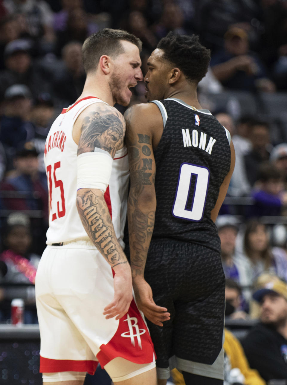 Houston Rockets guard Garrison Mathews (25) and Sacramento Kings guard Malik Monk (0) confront each other after colliding while chasing the ball during the second half in an NBA basketball game in Sacramento, Calif., Friday, Jan. 13, 2023. The Kings won 139-114. (AP Photo/José Luis Villegas)