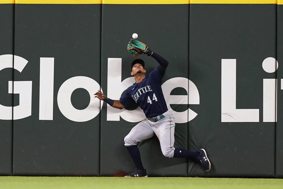 Seattle Mariners center fielder Julio Rodriguez catches a flyout against Texas Rangers Eli White during the third inning of a baseball game in Arlington, Texas, Saturday, June 4, 2022. (AP Photo/LM Otero)