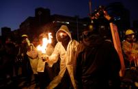 An anti-government protester holds a molotov cocktail during clashes with police, outside Hong Kong Polytechnic University