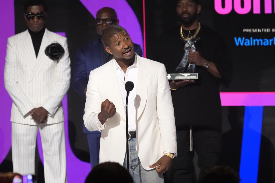 Usher accepts the Lifetime Achievement award during the BET Awards on Sunday, June 30, 2024, at the Peacock Theater in Los Angeles. Babyface, rear left, and L.A. Reid, rear center, look on.(AP Photo/Chris Pizzello)