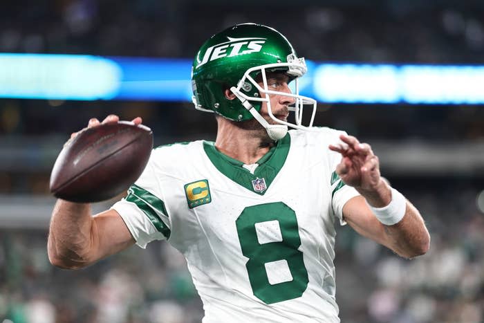 Aaron Rodgers #8 of the New York Jets passes as he warms up prior to a game