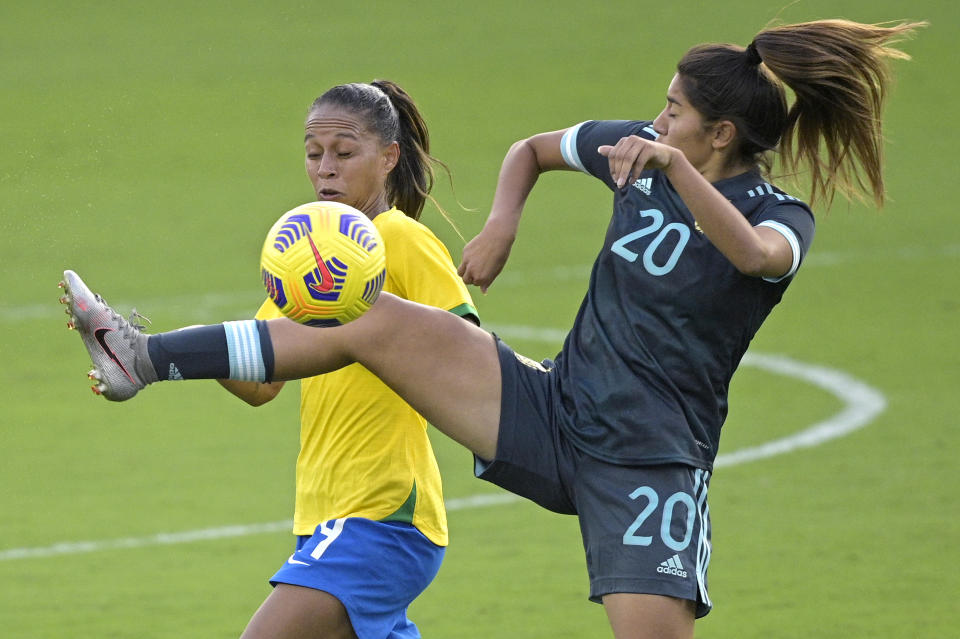 Brazil defender Rafaelle, left, and Argentina midfielder Daiana Falfan (20) battle for the ball during the second half of a SheBelieves Cup women's soccer match, Thursday, Feb. 18, 2021, in Orlando, Fla. (AP Photo/Phelan M. Ebenhack)