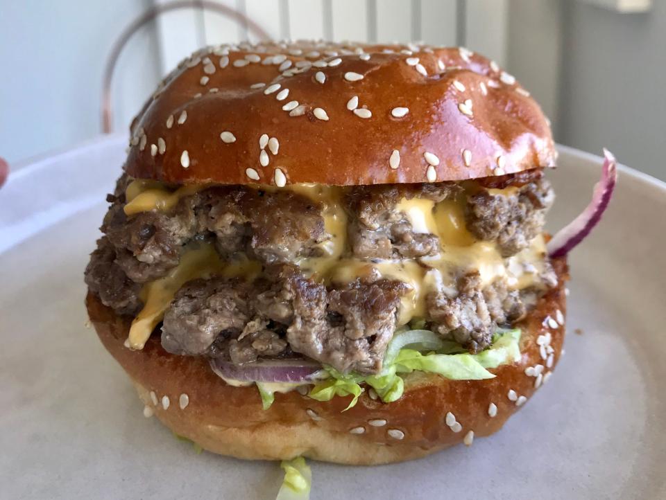 A double cheeseburger in a brioche bun.