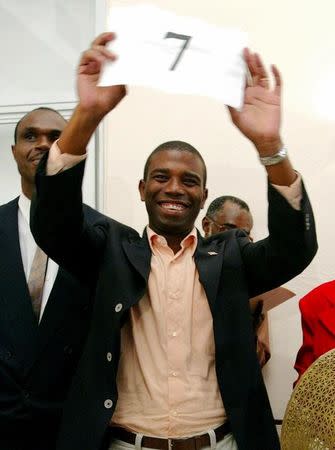 Guy Philippe holds his number while running as a candidate for the National Reconstruction Front (FNR) in the presidential election in Port-au-Prince, Haiti, October 31, 2005. REUTERS/Eduardo Munoz/Files