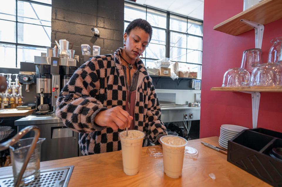 Kylie Kuhl prepares "Cold Matt" white espresso caramel coffee drinks for customers at Blackbox Cafe on Tuesday, April 16, 2024.