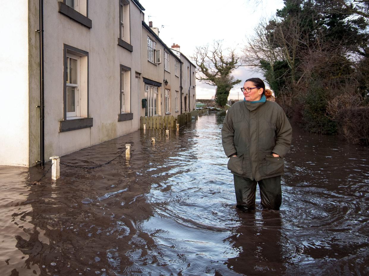 Gabrielle Burns-Smith outside her flooded home on the outskirts in Lymm (PA)