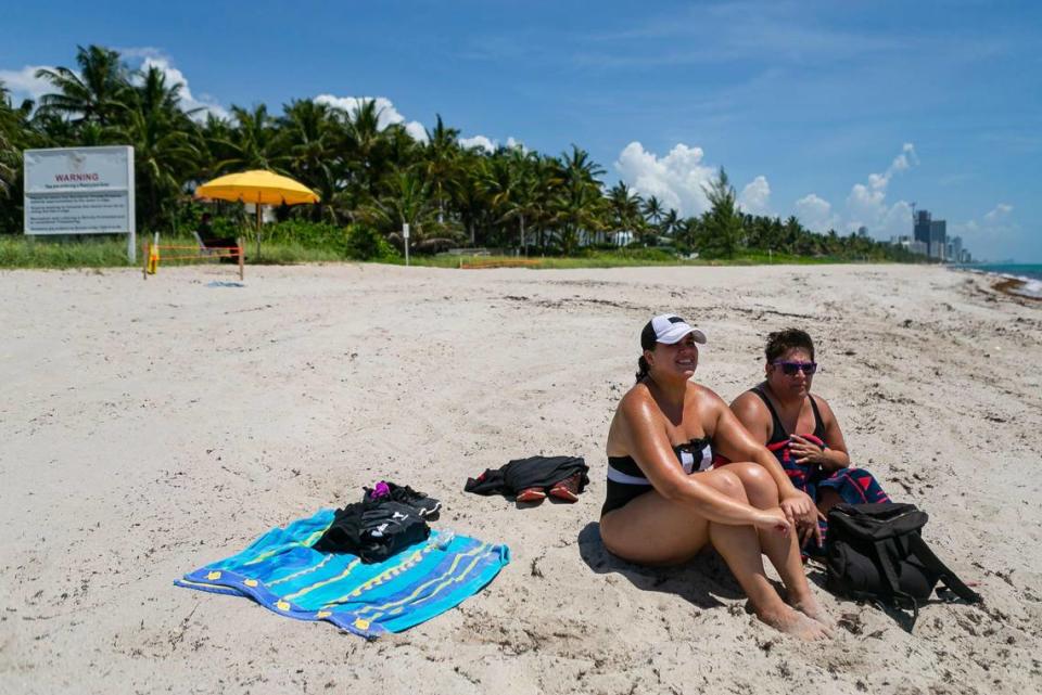 Mariapia Baquerizo, left, and Monica Correa, sunbathe on Sunny Isles Beach near the Golden Beach border.