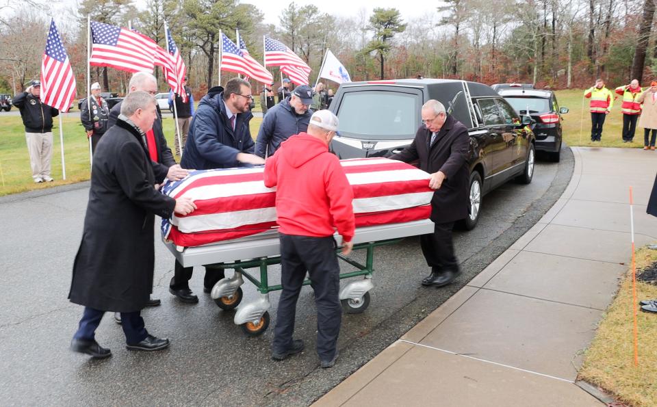 Vietnam War veteran Charles Connolly's casket is moved on Friday at Massachusetts National Cemetery in Bourne.