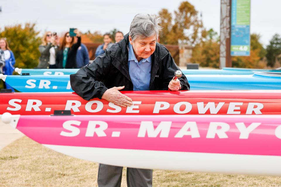 Sister Carolyn Stoutz with the Sisters of Mercy blesses a boat during a Saturday ceremony at Chesapeake Boathouse in Oklahoma City.