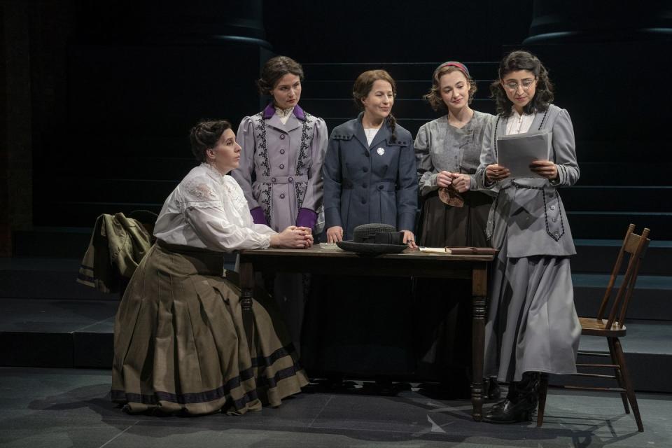 a group of people standing around a table