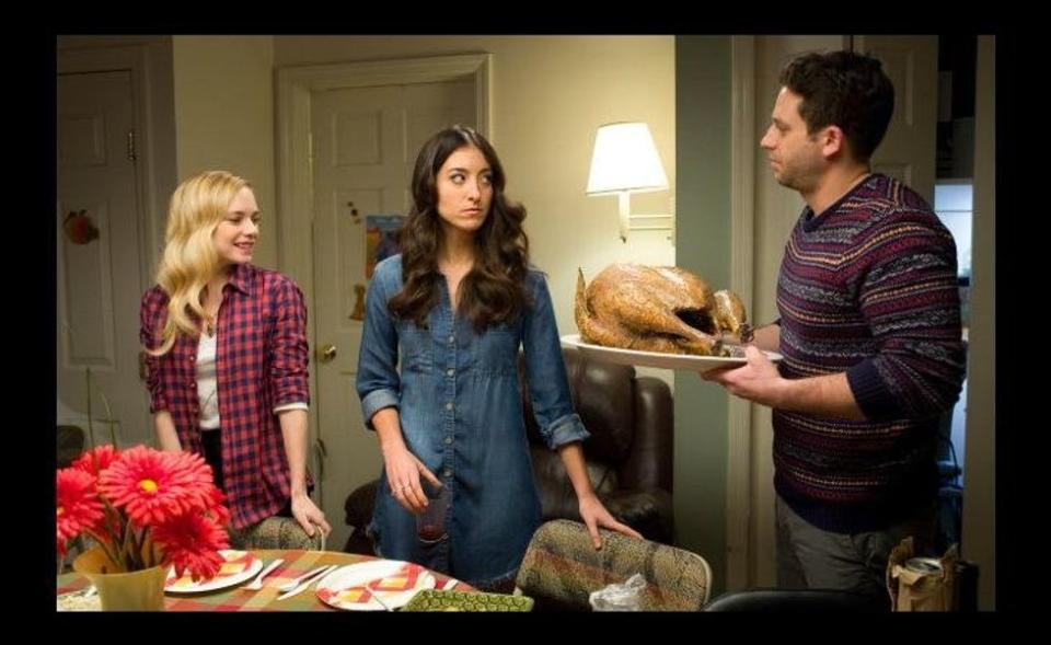 3 people around a Thanksgiving dinner table about to engage in conversations.