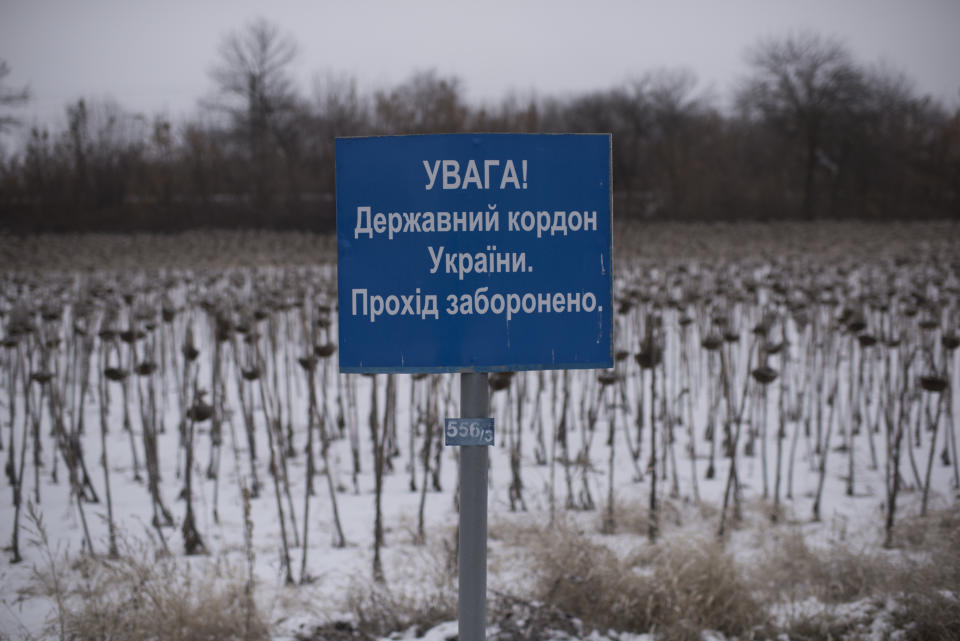 A sign reads "Attention, State Border of Ukraine, No Entry!" Is seen at the Ukrainian side of the Ukraine - Russia border in Milove town, eastern Ukraine, Sunday, Dec. 2, 2018. On a map, Chertkovo and Milove are one village, crossed by Friendship of Peoples Street which got its name under the Soviet Union and on the streets in both places, people speak a mix of Russian and Ukrainian without turning choice of language into a political statement. (AP Photo/Evgeniy Maloletka)
