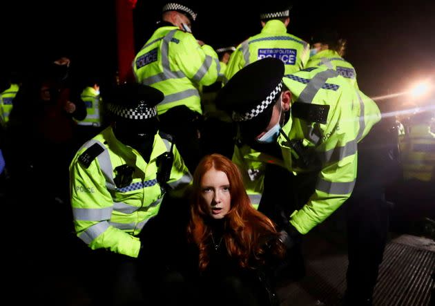 Police detain Patsy Stevenson as people gathered at a memorial site following the kidnap and murder of Sarah Everard. (Photo: Hannah Mckay via Reuters)