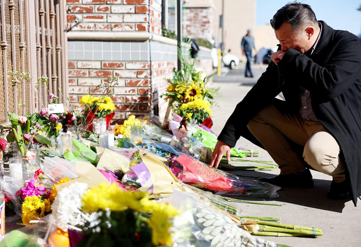 Monterey Park mayor Henry Lo kneels at a makeshift memorial outside the scene of a deadly mass shooting at a ballroom dance studio, in Monterey Park, Calif., on Jan. 23, 2023. (Mario Tama / Getty Images file)