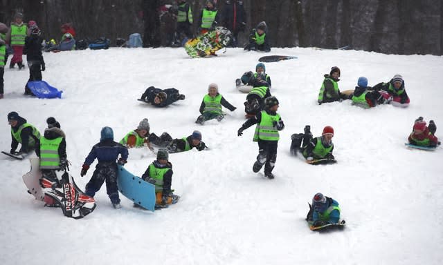 Children enjoy the snow-covered slopes in Oslo, Norwa