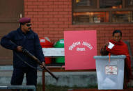 A woman casts her vote during the parliamentary and provincial elections in Bhaktapur, Nepal December 7, 2017. REUTERS/Navesh Chitrakar