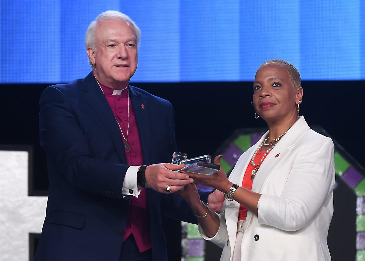 To acknowledge the transition in leadership for the UMC Council of Bishops, outgoing council president New York Bishop Rev. Thomas Bickerton passes the gavel to incoming council president Ohio Bishop Rev. Tracy Malone.