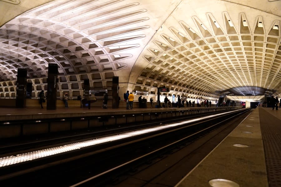 People wait for the train at a Metro station, on Jan. 6, 2022, in Washington.
