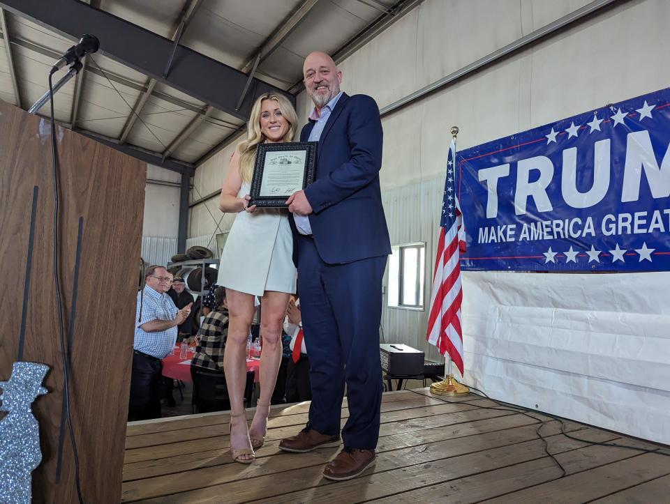 Riley Gaines receives a proclamation of support from State Rep. Gary Click, R-Vickery, at the Sandusky and Seneca Counties Annual Lincoln Reagan Hayes Day Dinner on May 8, 2024. She was the featured guest speaker for the event.